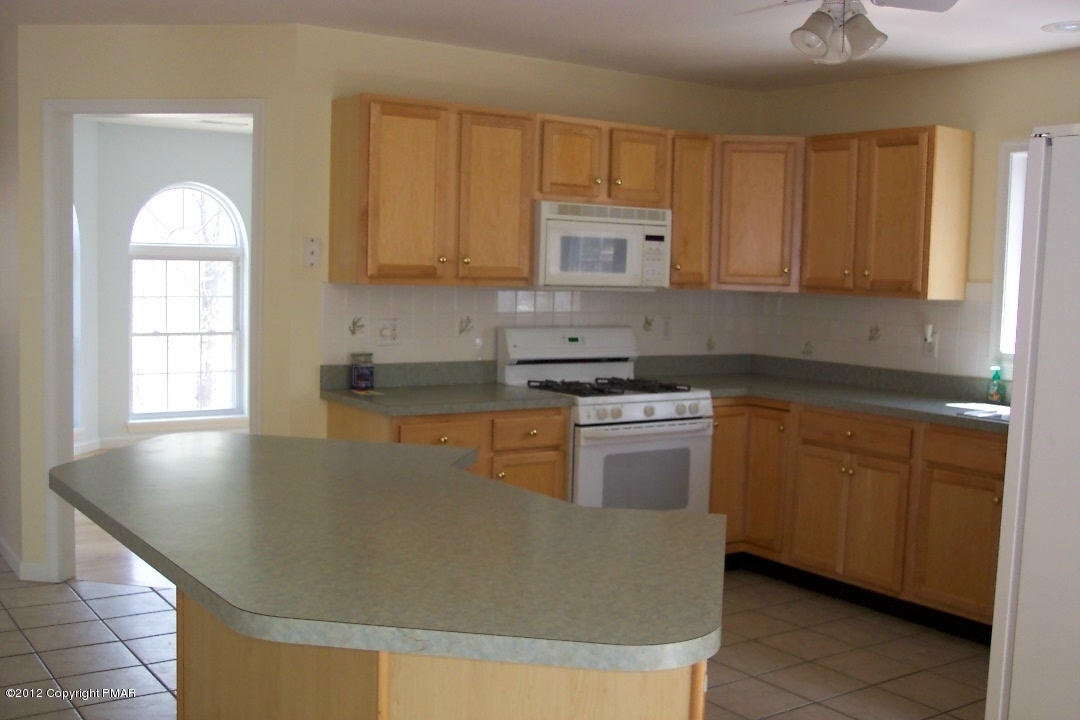 281 Frailey Road Stroudsburg, PA 18360 - Photo 8 of 44 a kitchen with granite countertop a sink stainless steel appliances and cabinets