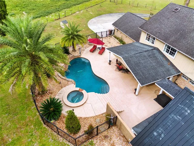 a view of a patio with table and chairs under an umbrella