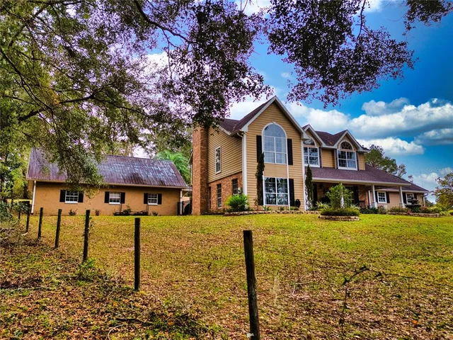a front view of a house with swimming pool having outdoor seating