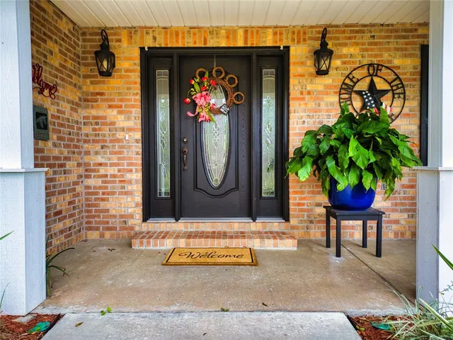 a view of a patio with a table chairs and a small yard