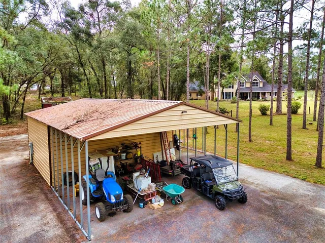 an aerial view of a house with swimming pool and porch