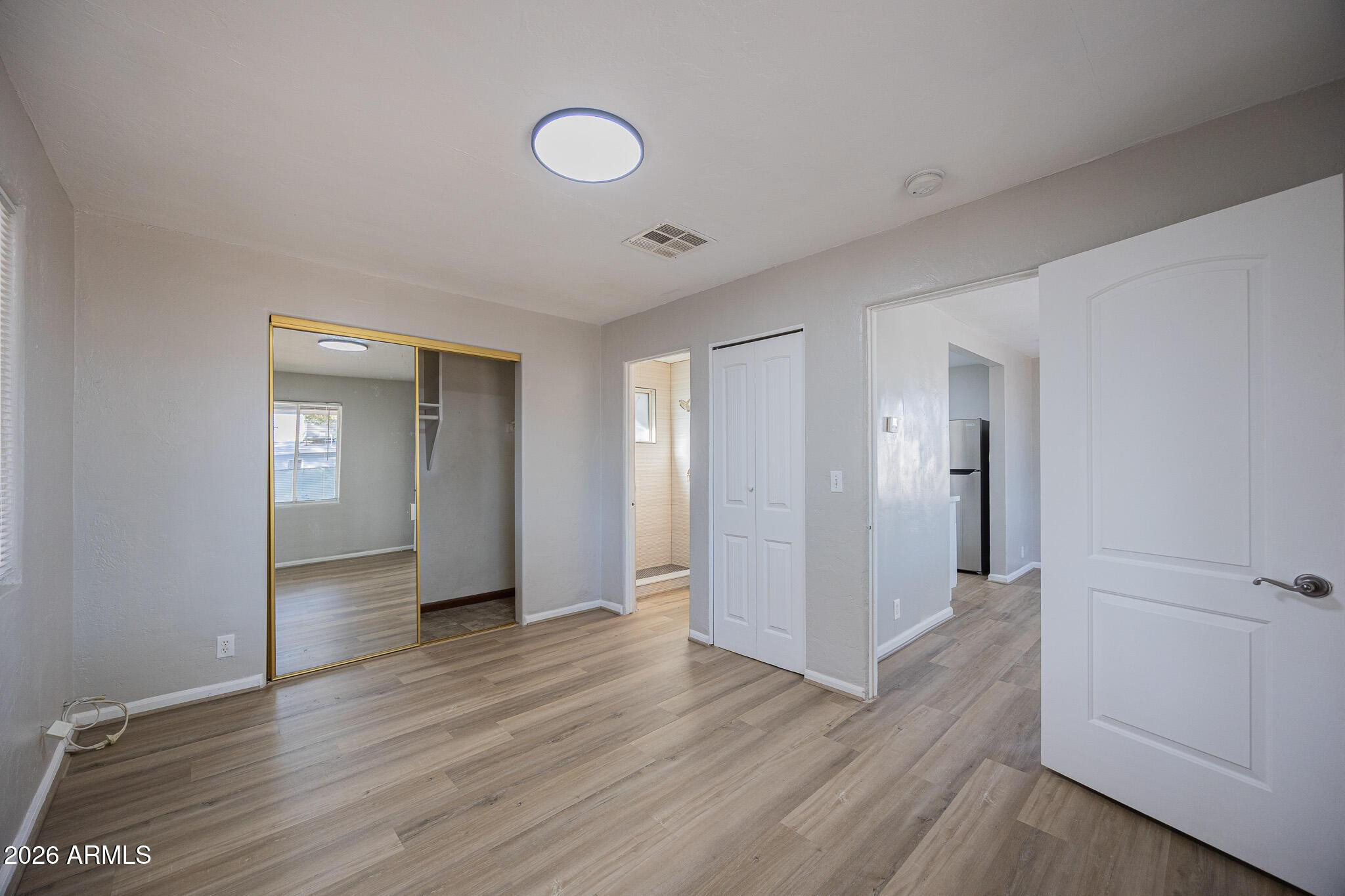 4208 North 17th Street, Unit 2 Phoenix, AZ 85016 - Photo 13 of 18 a view of wooden floor and windows in a room