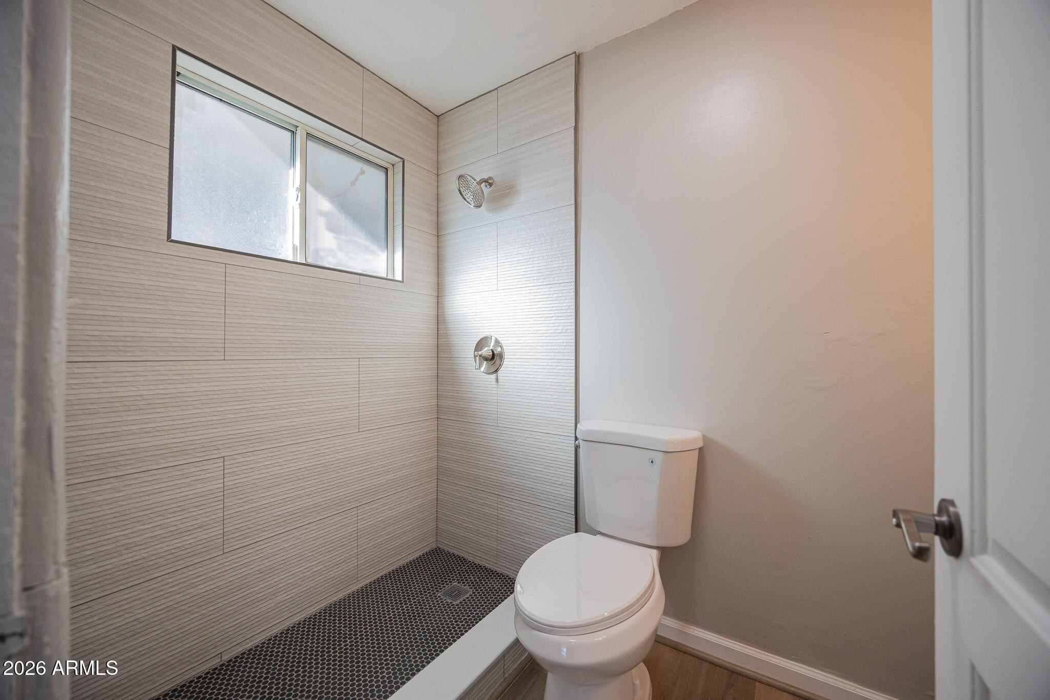 4208 North 17th Street, Unit 2 Phoenix, AZ 85016 - Photo 14 of 18 a bathroom with a granite countertop toilet a sink and a shower