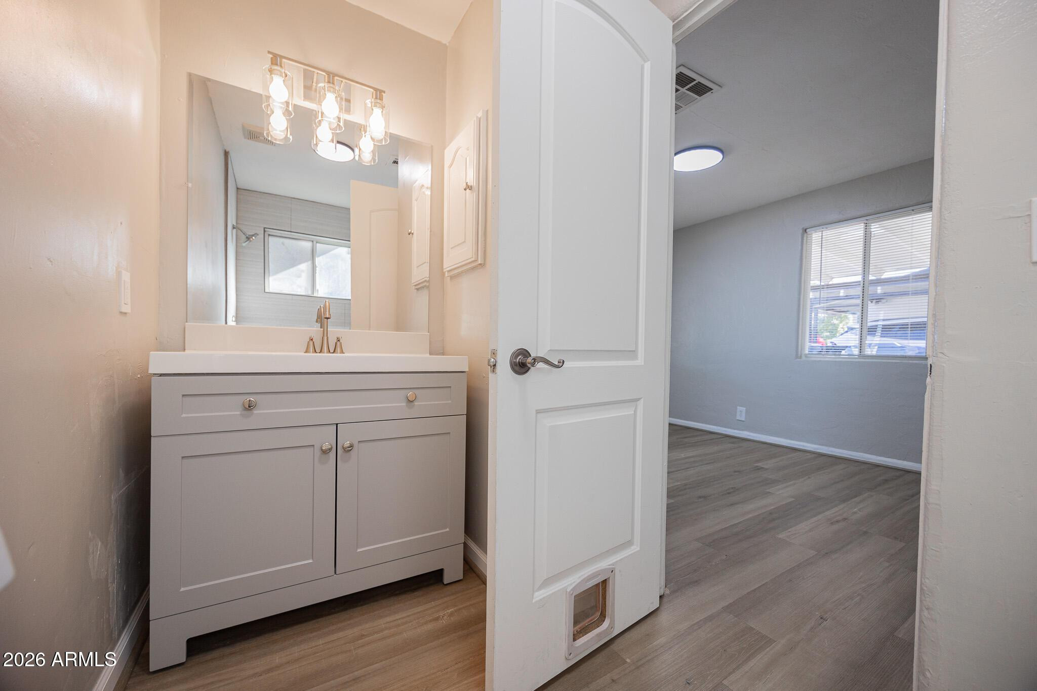 4208 North 17th Street, Unit 2 Phoenix, AZ 85016 - Photo 15 of 18 a bathroom with a sink mirror and a window