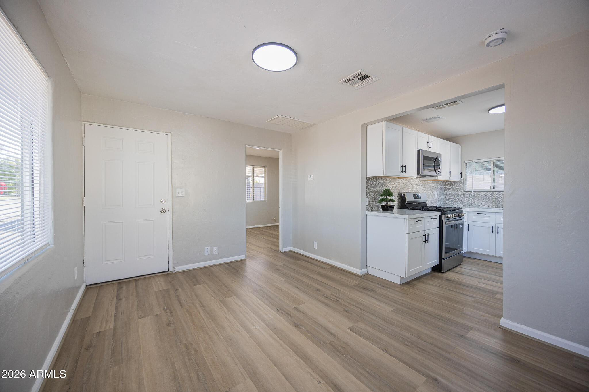 4208 North 17th Street, Unit 2 Phoenix, AZ 85016 - Photo 4 of 18 a view of kitchen with wooden floor electronic appliances and window