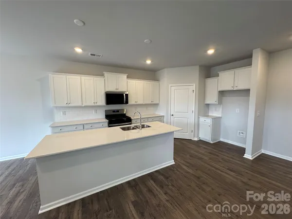 a view of kitchen with wooden floor