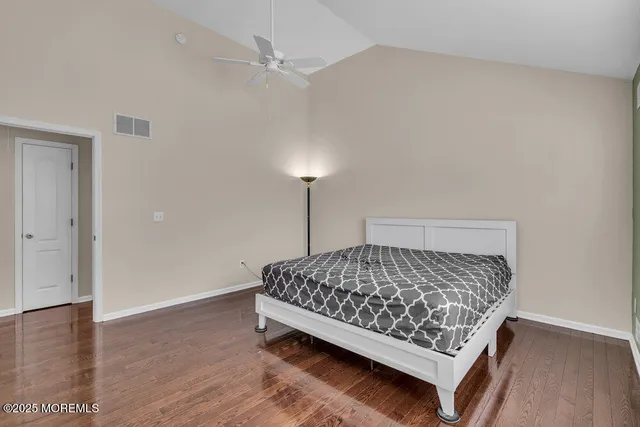 a bed sitting in a bedroom next to a lamp