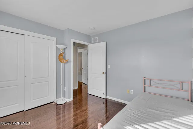 a view of a room with wooden floor