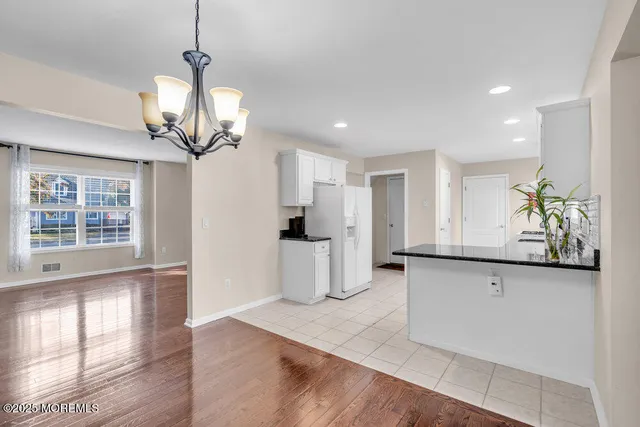 a view of a kitchen with a sink and chandelier