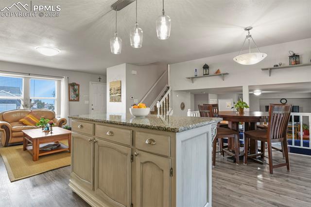 5160 Victory Road Colorado Springs, CO 80911 - Photo 10 of 31 Kitchen featuring an open concept to the living room and see through to the lower level