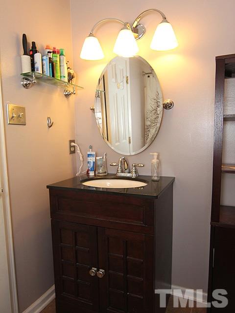 5412 Middleton Road Durham, NC 27713 - Photo 13 of 18 a bathroom with a sink vanity and mirror
