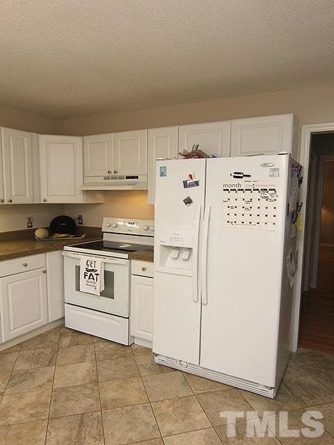 5412 Middleton Road Durham, NC 27713 - Photo 16 of 18 a kitchen with white cabinets and white appliances