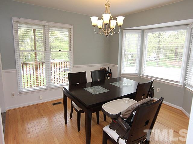 5412 Middleton Road Durham, NC 27713 - Photo 4 of 18 a view of a dining room with furniture wooden floor and chandelier