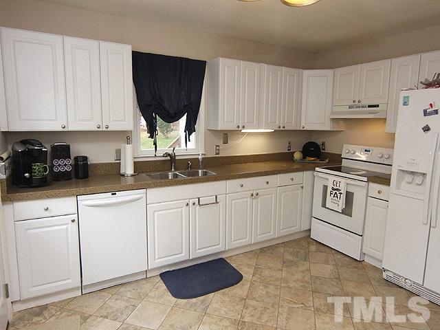 5412 Middleton Road Durham, NC 27713 - Photo 5 of 18 a kitchen with white cabinets and white appliances