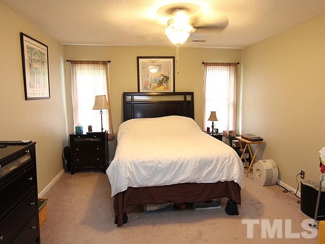 5412 Middleton Road Durham, NC 27713 - Photo 9 of 18 a bedroom with a bed and wooden floor