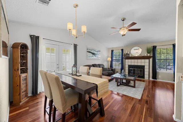 a view of a dining room with furniture wooden floor and a chandelier