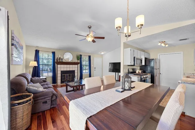 a living room with furniture a fireplace and a chandelier