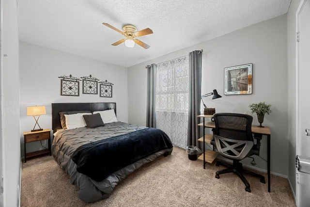 a bedroom with a bed and a window