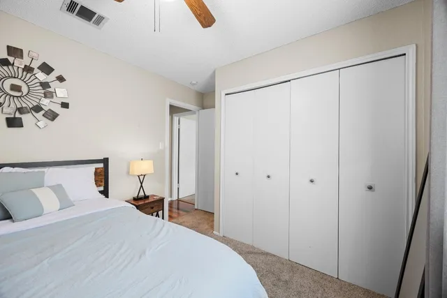 a bedroom with a large bed and a chandelier