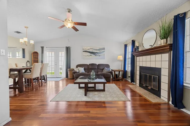 a living room with furniture or wooden floor and a fireplace