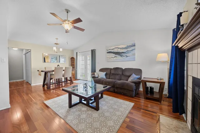 a living room with furniture and wooden floor