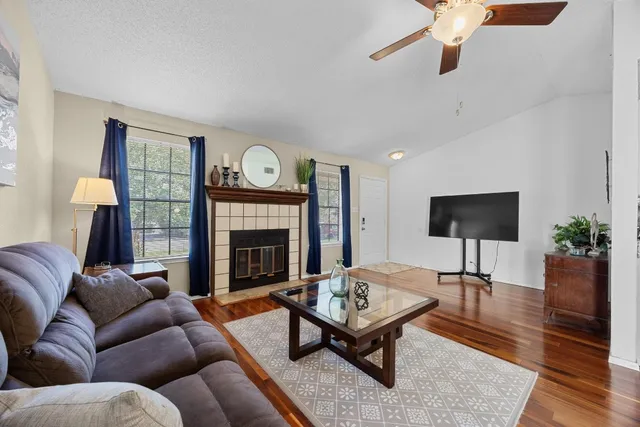 a living room with furniture fireplace and window
