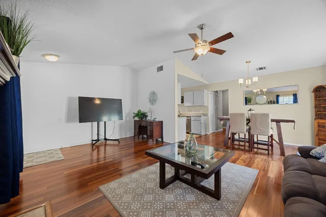 a living room with furniture a rug and a flat screen tv