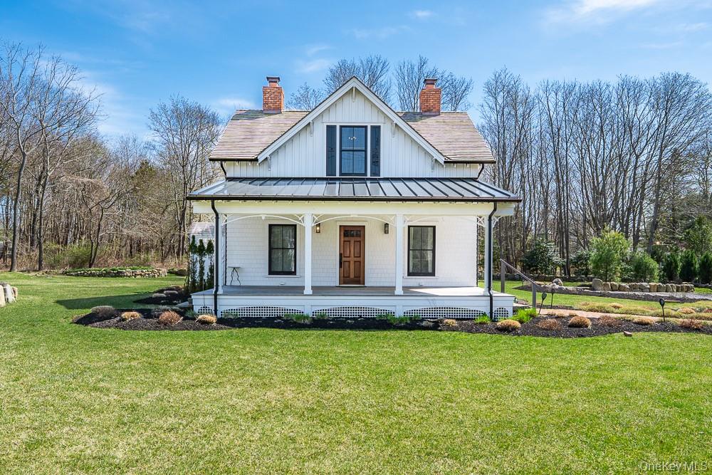 19000 Main Road Mattituck, NY 11952 - Photo 2 of 32 Modern farmhouse style home with a standing seam roof, a porch, a chimney, a front yard, and metal roof