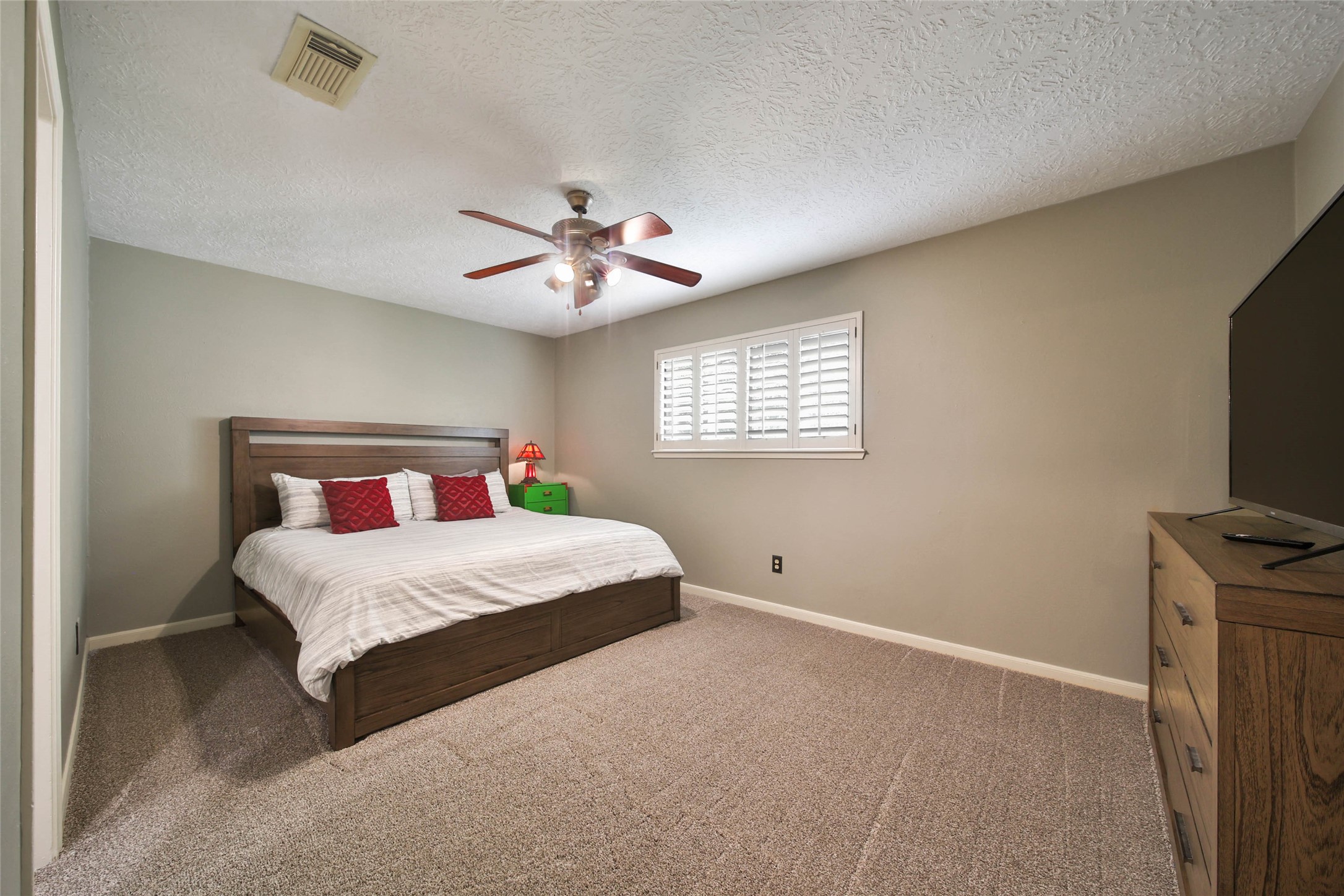 17007 Windrow Drive Spring, TX 77379 - Photo 30 of 46 a bedroom with a bed and a flat screen tv