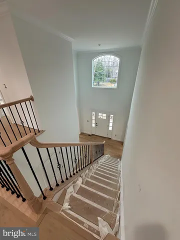 a view of staircase with white walls and a window