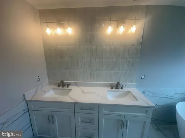 a bathroom with a sink vanity and a mirror