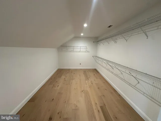 a view of a room with wooden floor and white walls