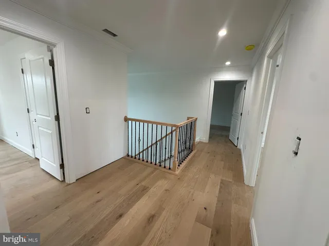 an entryway with staircase and white walls