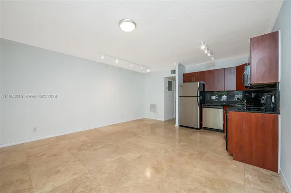 a view of kitchen with stainless steel appliances a refrigerator and a stove top oven