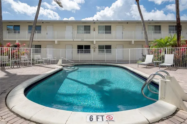 a view of a house with swimming pool and porch