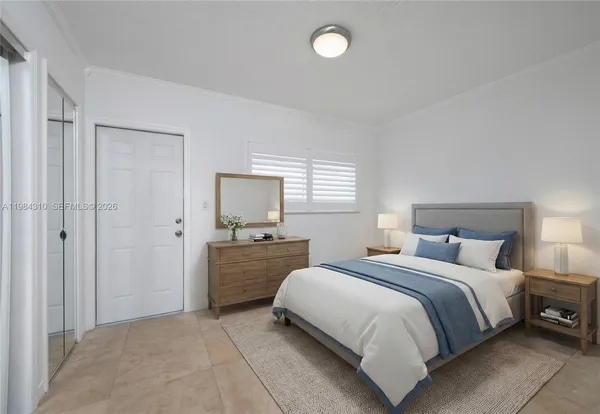 a bedroom with a bed and a couch