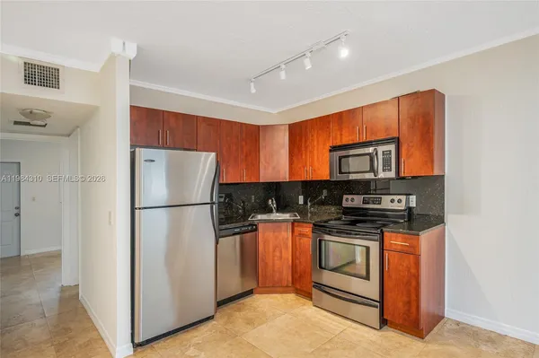 a kitchen with stainless steel appliances granite countertop a refrigerator stove a sink and dishwasher