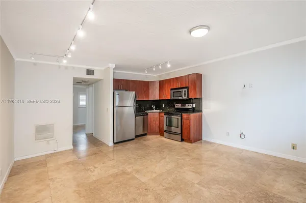 a kitchen with stainless steel appliances a refrigerator and a stove top oven