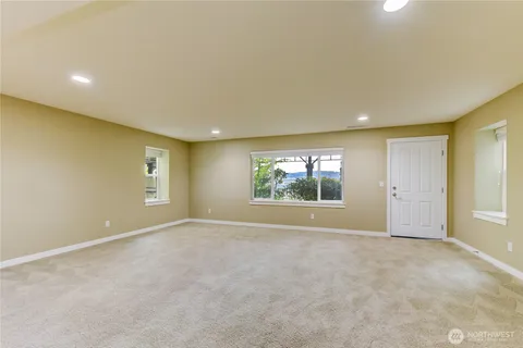 a bathroom with a granite countertop toilet and a shower