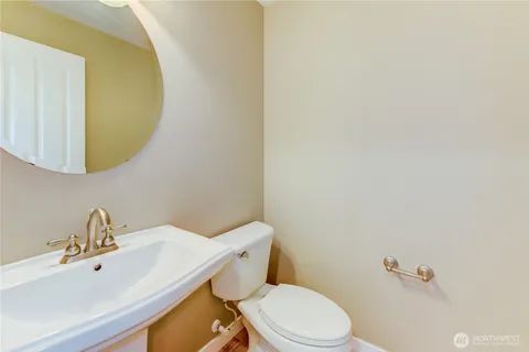 a white toilet sitting next to a bathroom sink