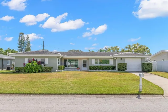 a view of house with a yard