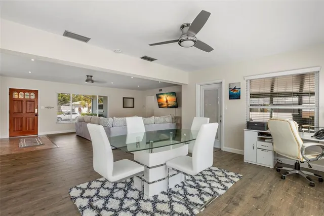 a living room with furniture and a view of kitchen
