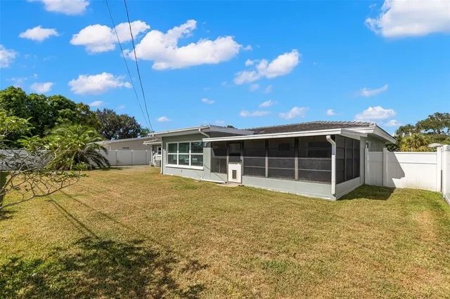 a view of a house with a backyard