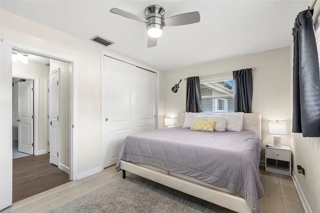 a bedroom with a bed and wooden floor
