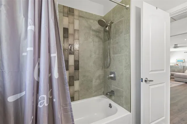 a bathroom with a bathtub and shower