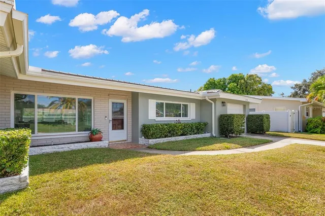 a view of a house with swimming pool and a yard