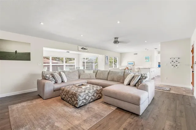 a living room with furniture and a book shelf