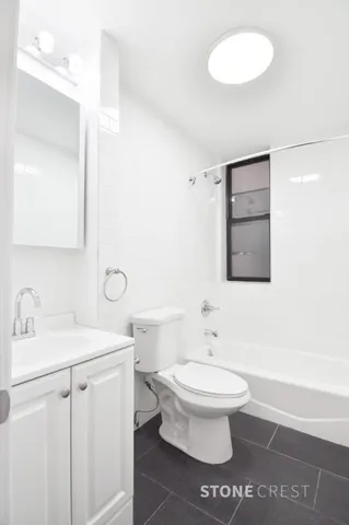 a bathroom with a sink toilet and mirror