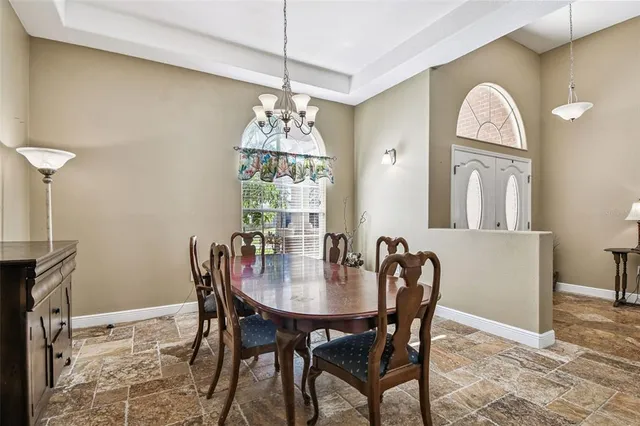 a view of a dining room with furniture and chandelier