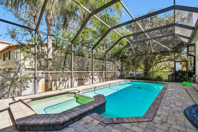 a view of a backyard with swimming pool